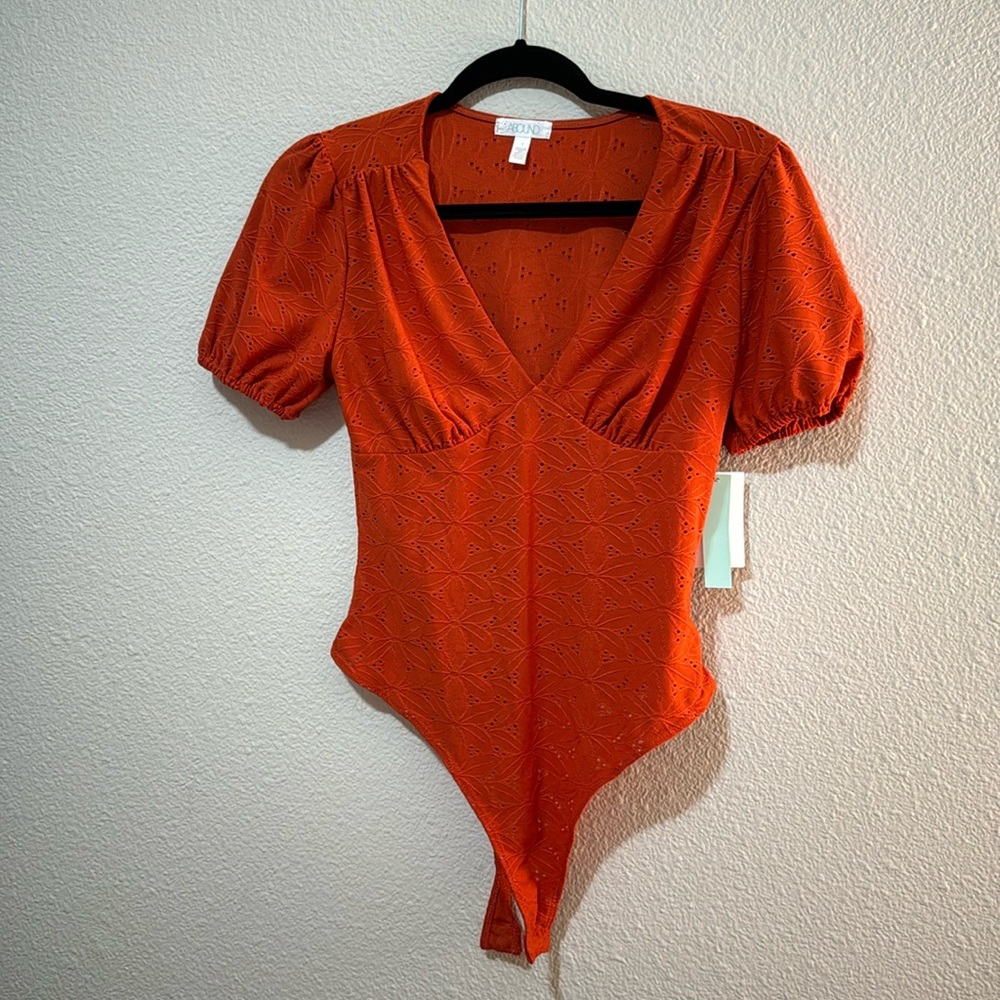 Orange eyelet bodysuit